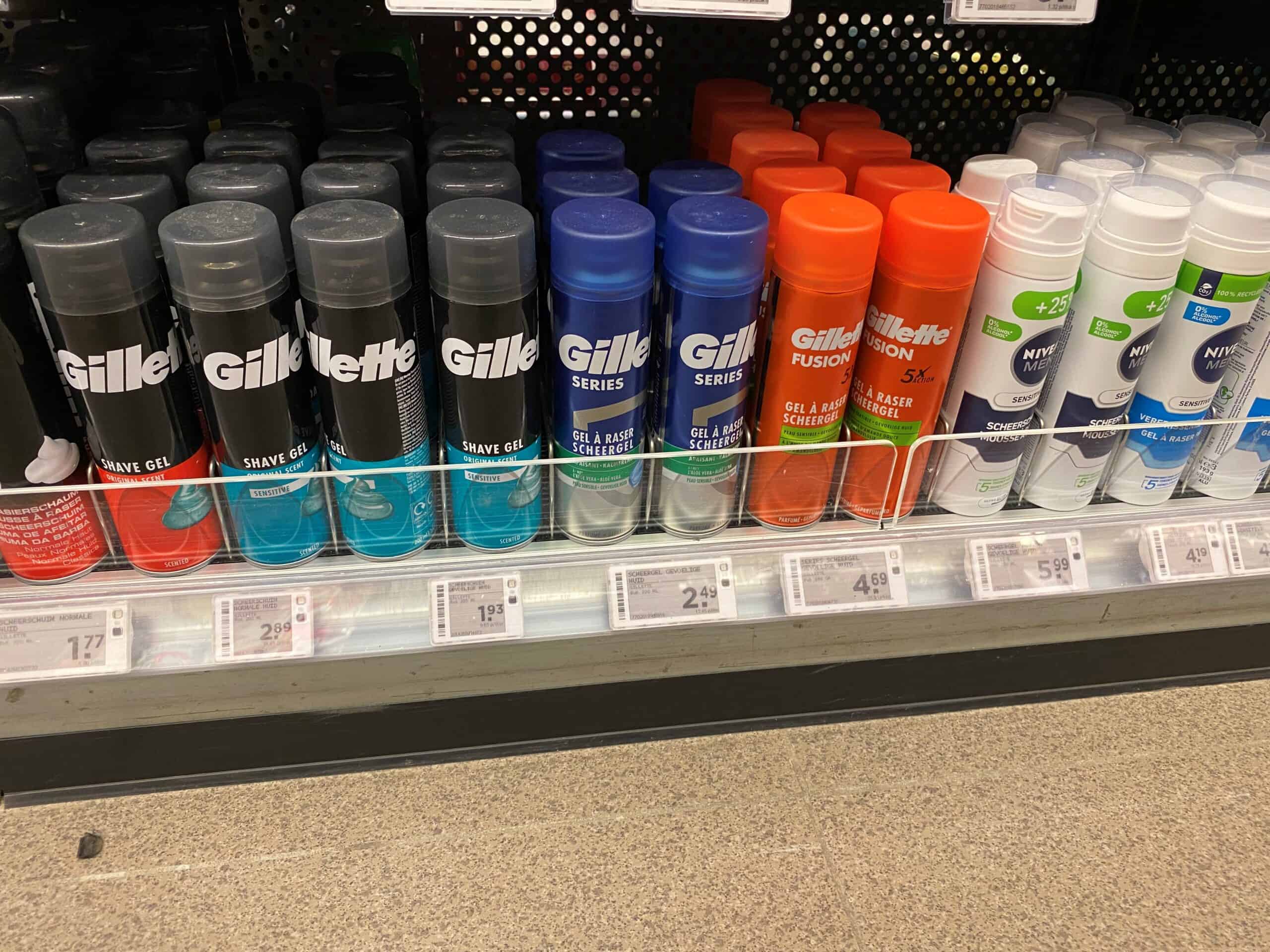 Sprayverzorging en scheerproducten van Gillette en Nivea op winkelrek met prijslabels.