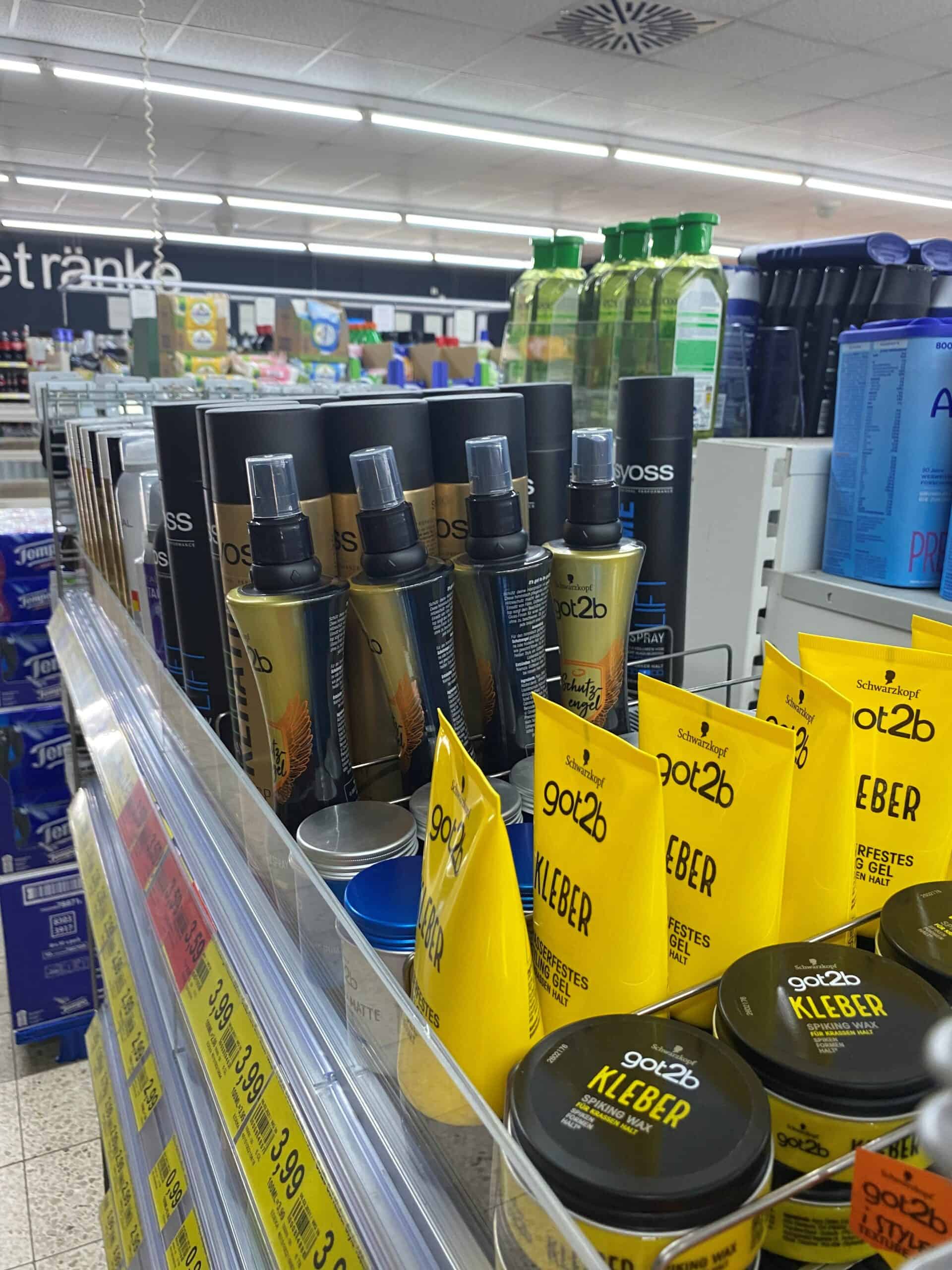 Halte voor automatische reinigingsproducten bij Elips Solutions in een supermarkt, inclusief sprays, gels en wasmiddelen, met duidelijke etiketten en prijskaartjes.